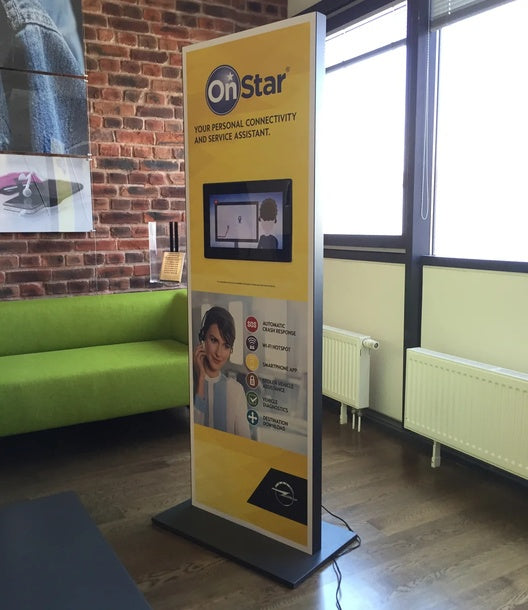 Präsentations-Display mit Monitor – freistehende Werbestele mit integriertem Bildschirm und gelber Markenbedruckung, Indoor-Aufstellung in Wiesbaden von City Medien Einkaufswelt für Partner günstig kaufen, drucken lassen, online preiswert bestellen – Displays, Messen, Präsentationssysteme