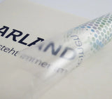 Aufkleber Polymer 2D weiß und transparent – Nahaufnahme einer halb abgezogenen, durchscheinenden Folie mit mehrfarbigem Punktemuster in Wiesbaden von City Medien Einkaufswelt für Partner günstig kaufen, drucken lassen, online preiswert bestellen – Aufkleber, Folien, Sticker